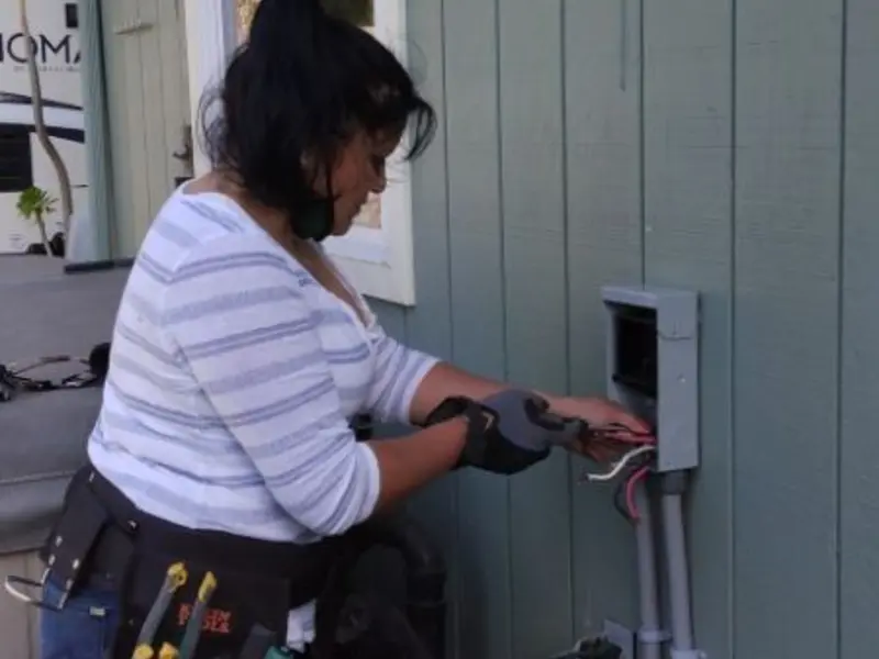 Licensed electrician wiring an exterior subpanel in Gibson City