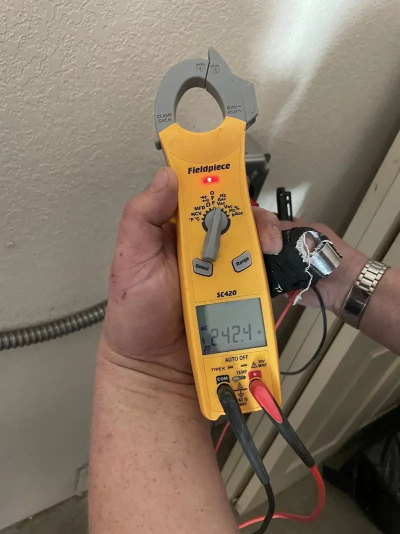 Voltage testing with clamp meter during Recessed Lighting Installation in Gibson City
